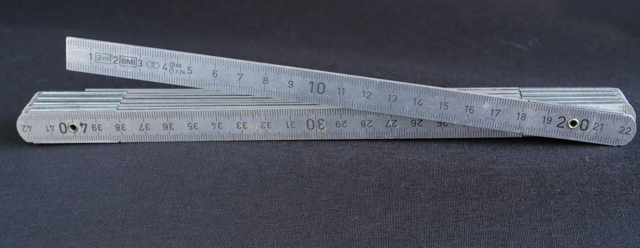 An aluminium folding rule stamped 2 m with centimetre numbering