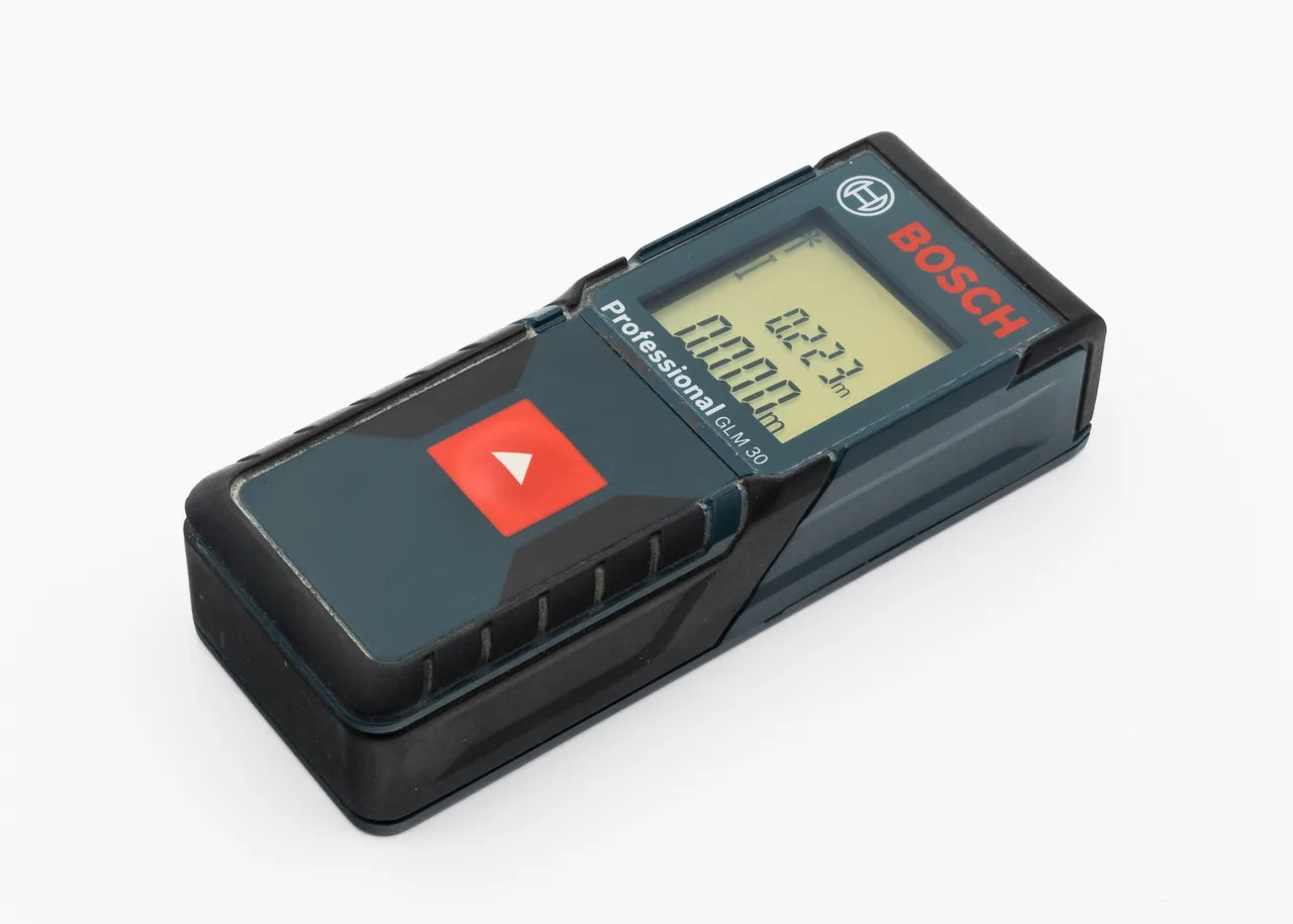 The display of a laser distance meter showing a reading of 0.223 metres