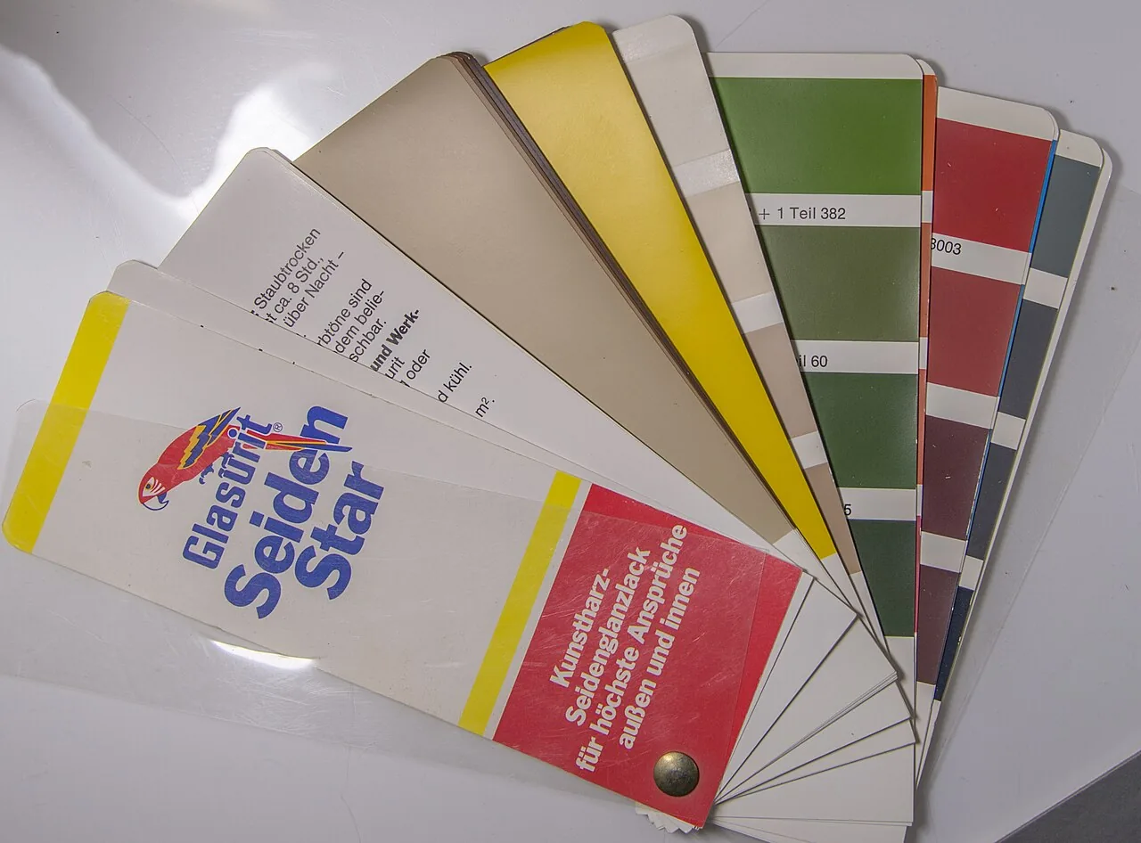 A paint fan deck with shade numbers on the swatches