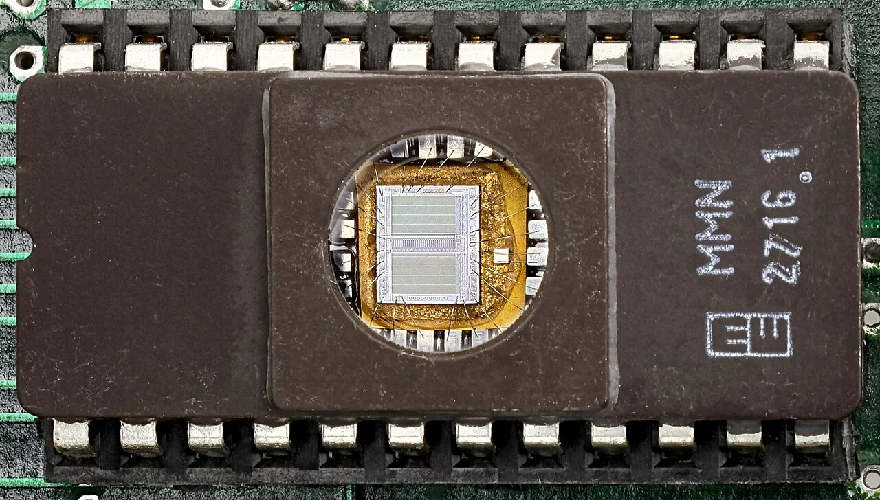 An EPROM chip marked 2716 with a quartz window that shows the silicon inside