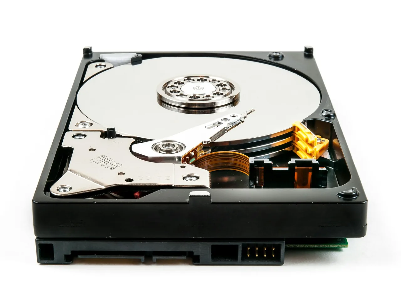 A hard drive with the cover removed, showing the platter and the head arm