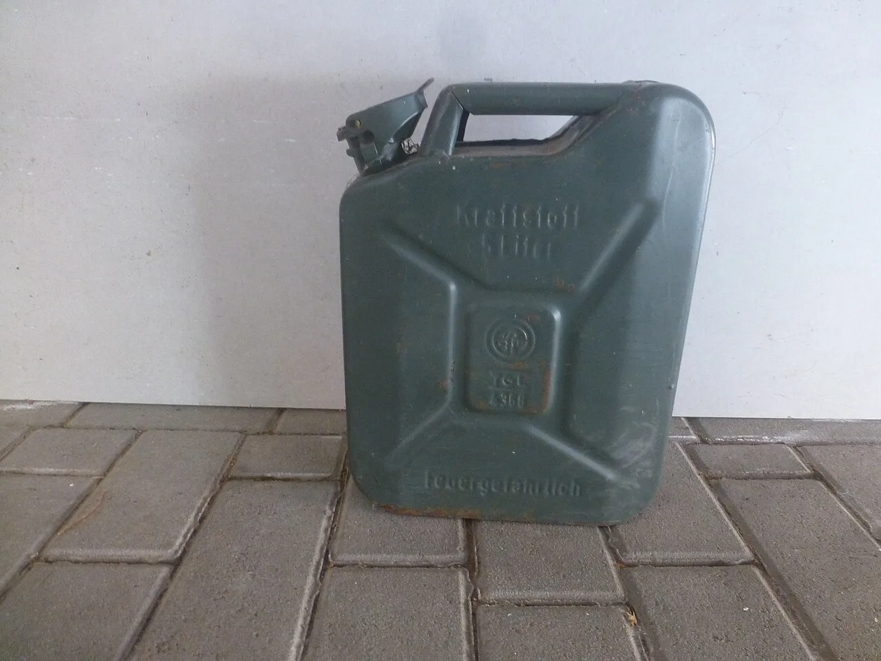 A metal fuel canister embossed with the words 5 Liter