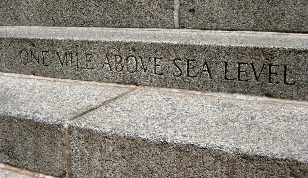 A stone step carved with the words ONE MILE ABOVE SEA LEVEL