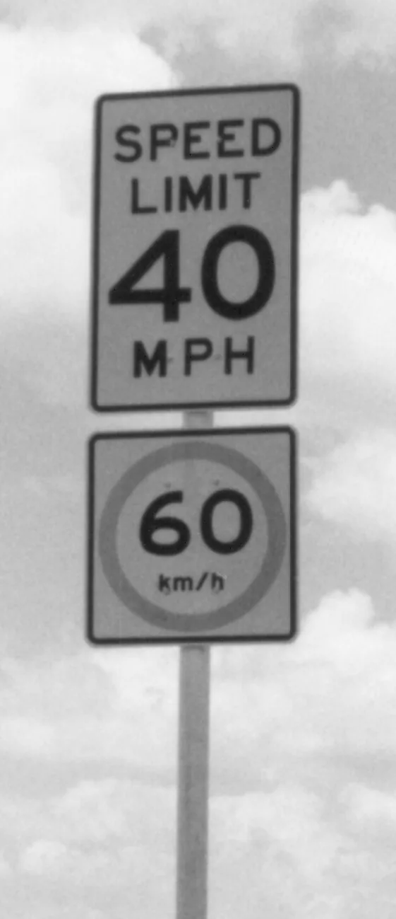American road sign showing a limit of 40 miles per hour and 60 km/h