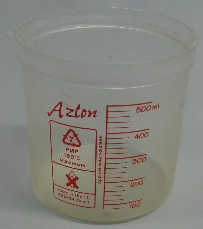 A laboratory beaker with a red scale from 100 to 500 millilitres