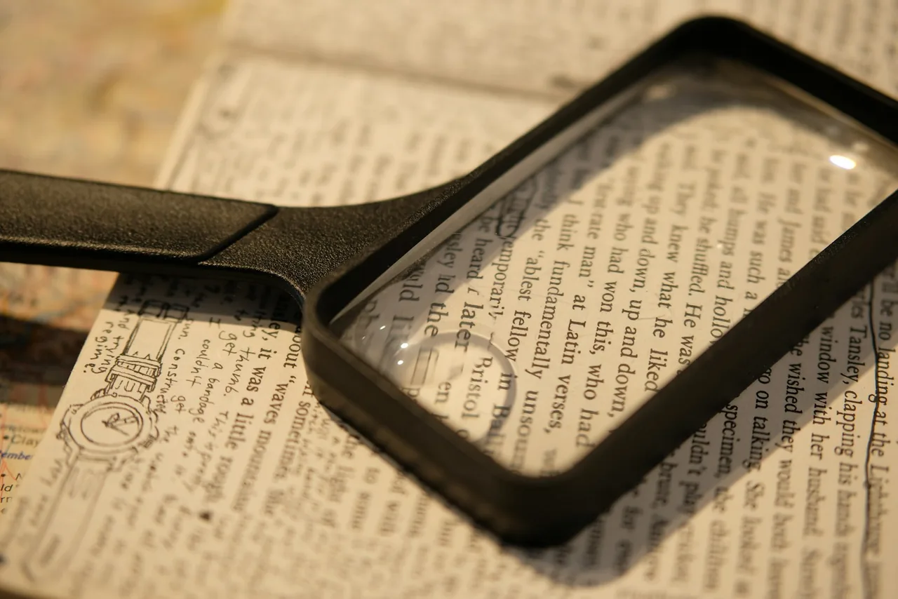 A rectangular magnifying glass lying on a page of small print