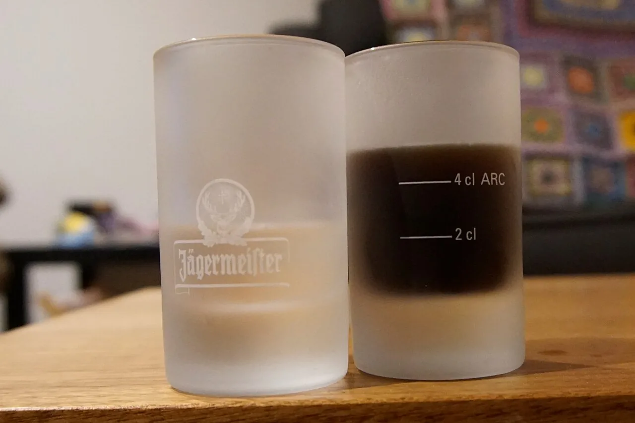 Two shot glasses standing side by side